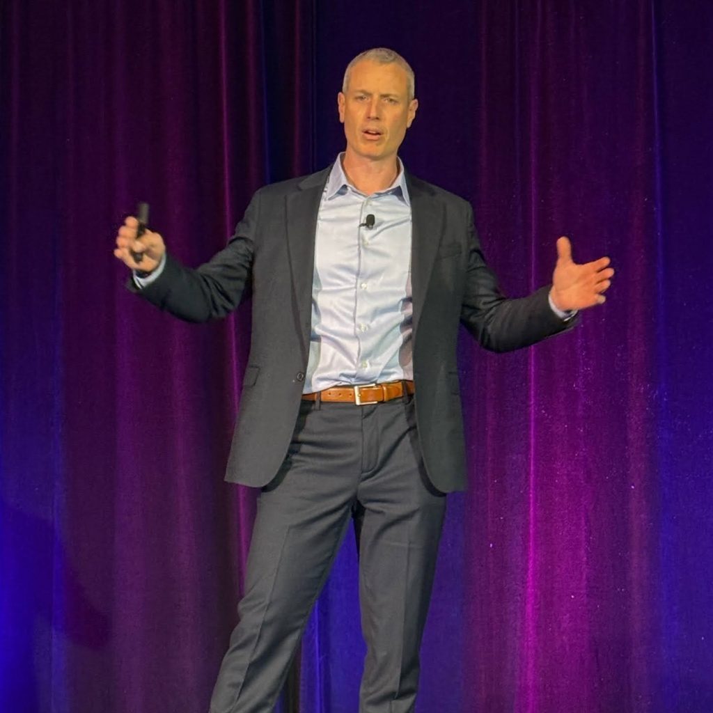 Dr. Joe Chichetti speaking on stage